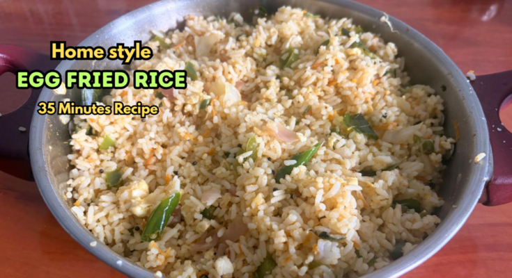 Home-style egg fried rice with cabbage, capsicum, carrot and curry leaves in a kadai